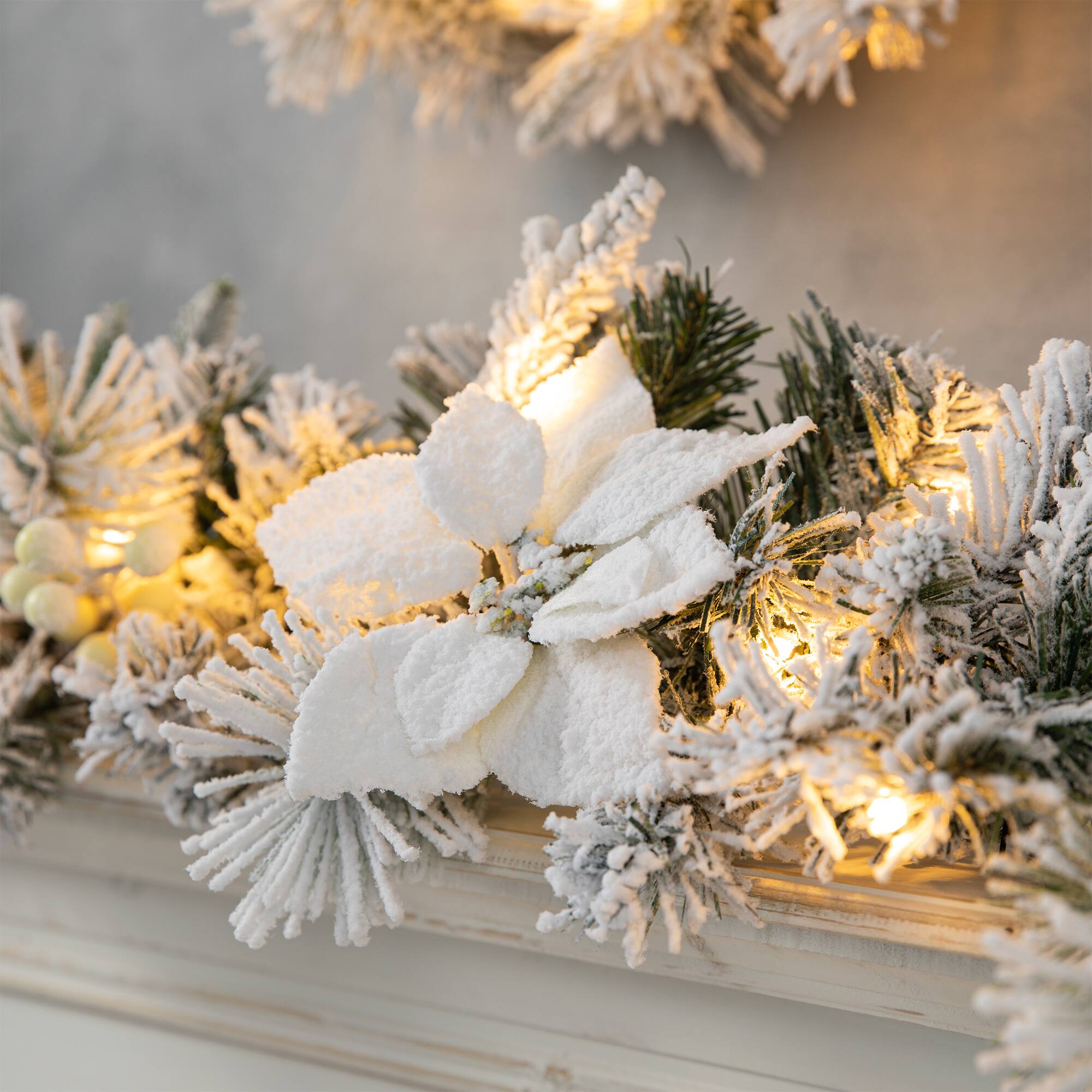 Glitzhome® 9ft. Pre-Lit Snow Flocked Greenery Pine Poinsettia Christmas Garland